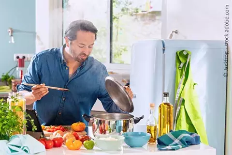 Mann beim Kochen mit frischen Zutaten