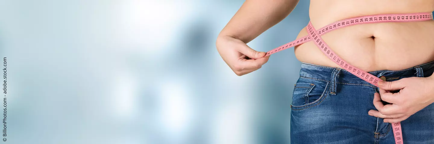 Frau misst Taillenumfang mit Massband